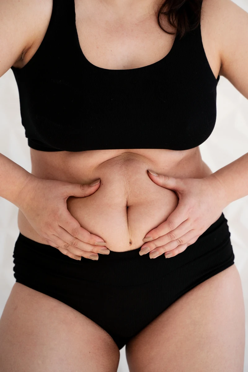 front-view-woman-holding-her-belly